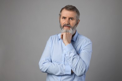 Photo of Portrait of mature man on grey background