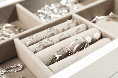 Photo of Many beautiful rings in jewelry box, closeup