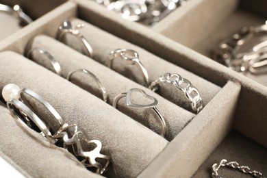 Photo of Many beautiful rings in jewelry box, closeup