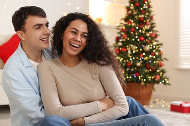 Photo of Happy couple spending time together at home. Christmas celebration