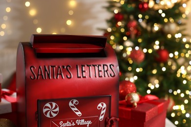 Photo of Santa Claus mailbox and Christmas decor indoors, closeup