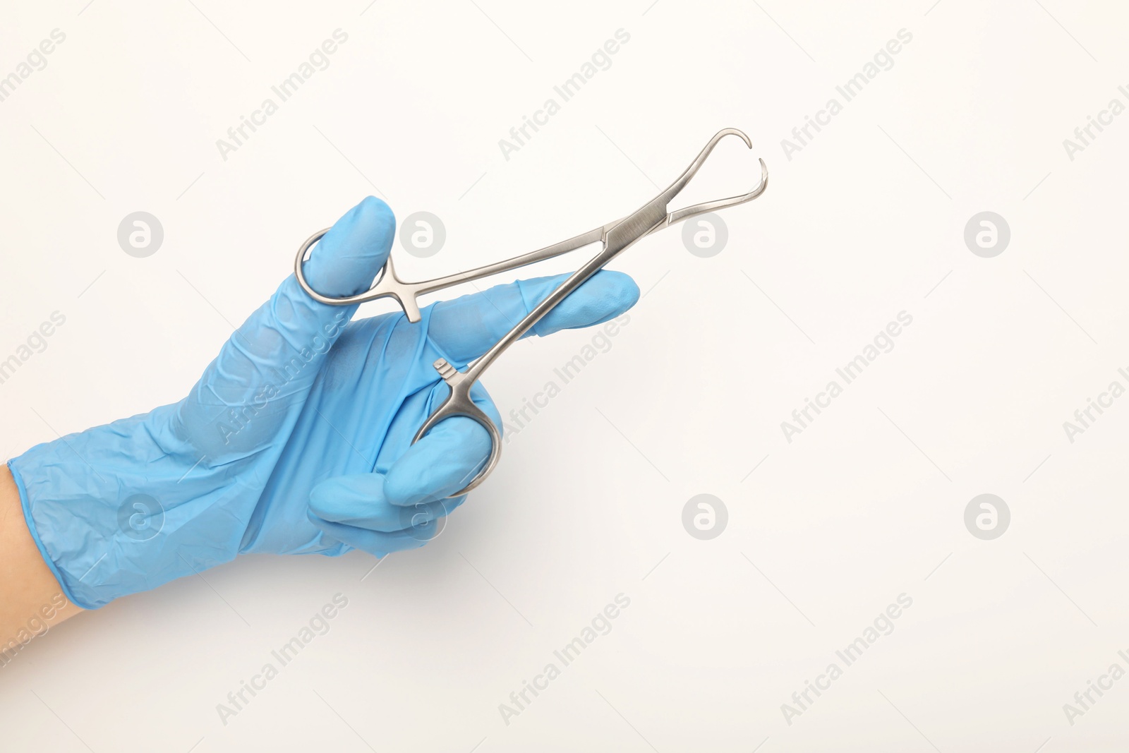 Photo of Doctor holding backhaus forceps on light background, top view with space for text. Surgical tool