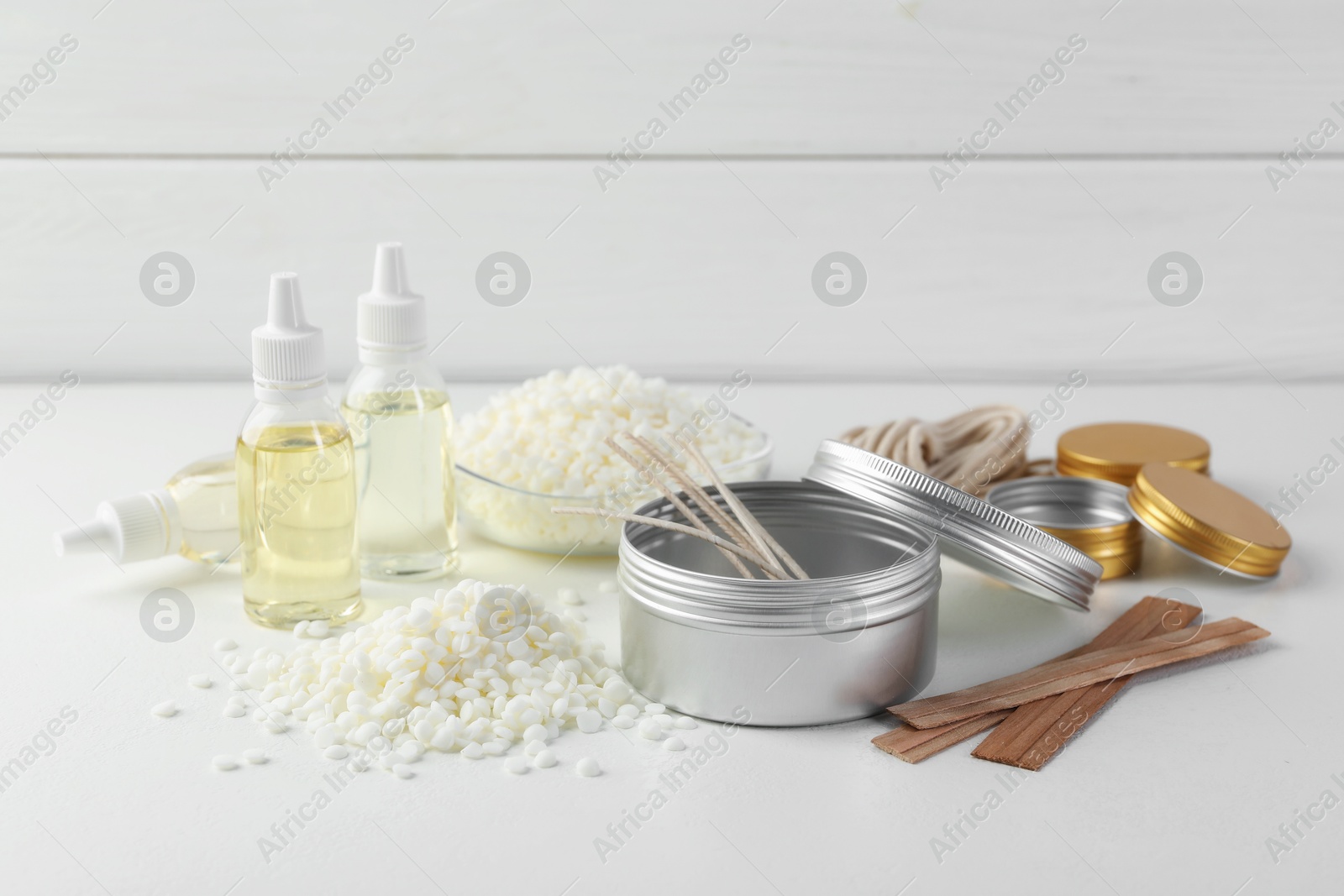 Photo of Soy wax and other supplies for making candles on white table