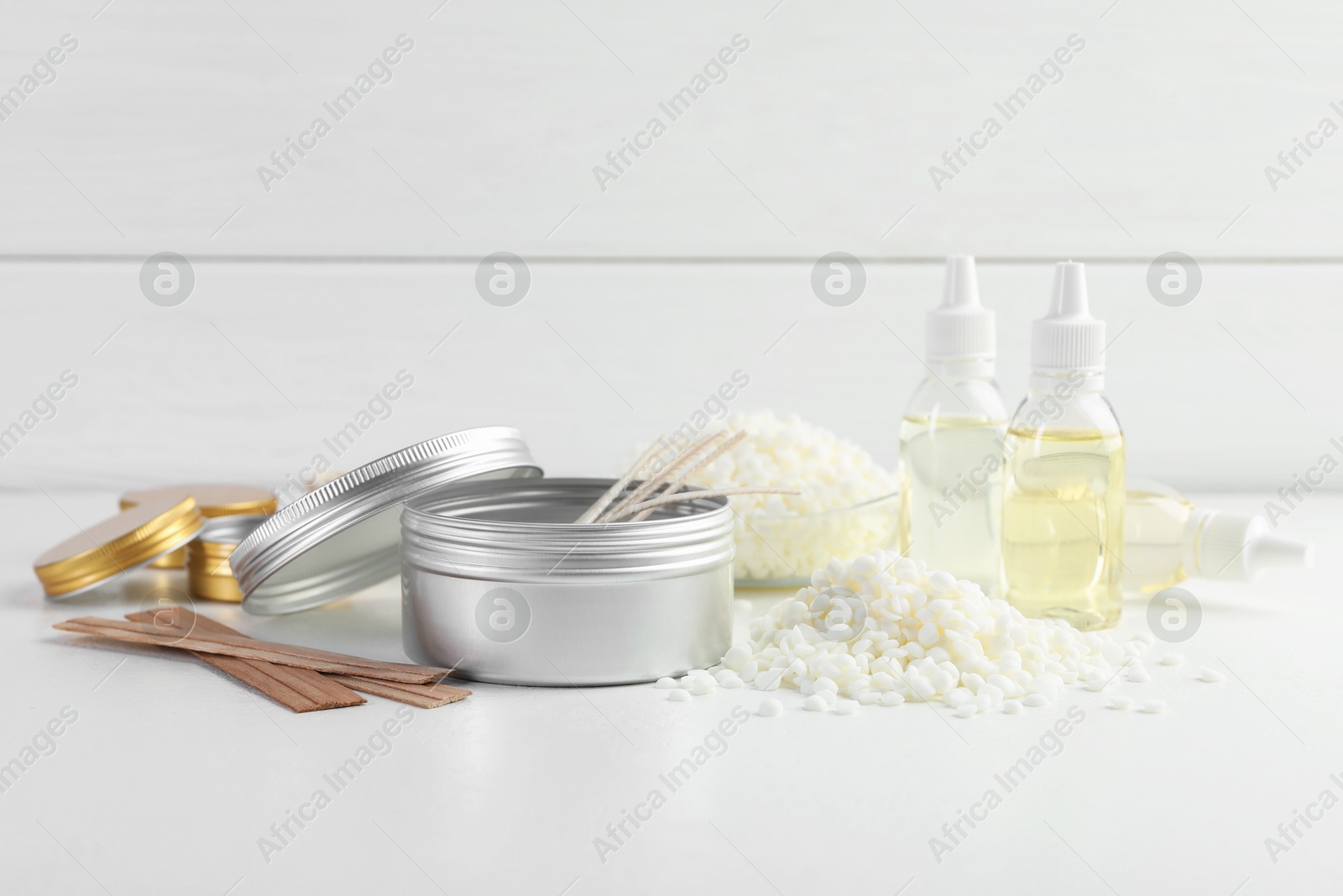 Photo of Soy wax and other supplies for making candles on white table