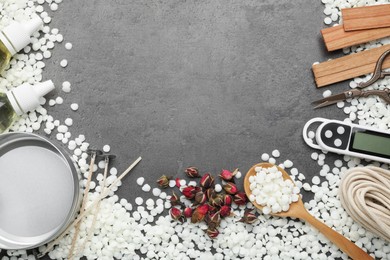 Photo of Soy wax and other supplies for making candles on grey table, flat lay. Space for text