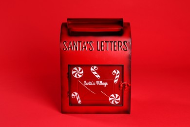 Photo of Santa Claus mailbox on red background. Christmas tradition