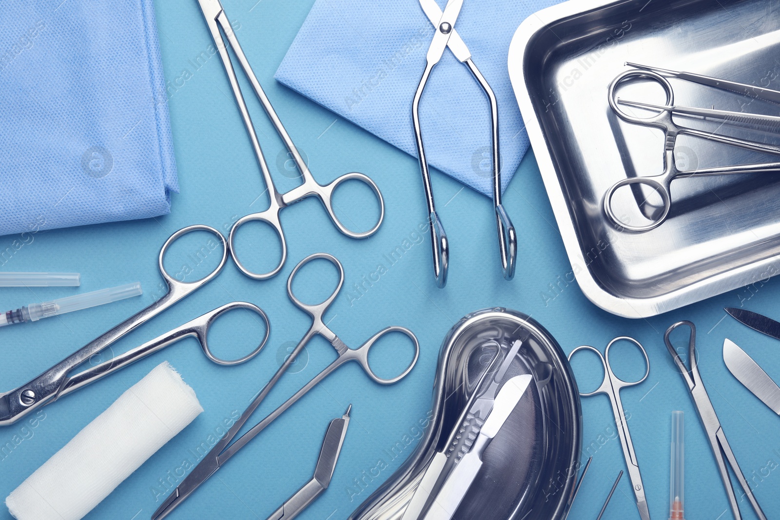 Photo of Different surgical tools on light blue background, flat lay