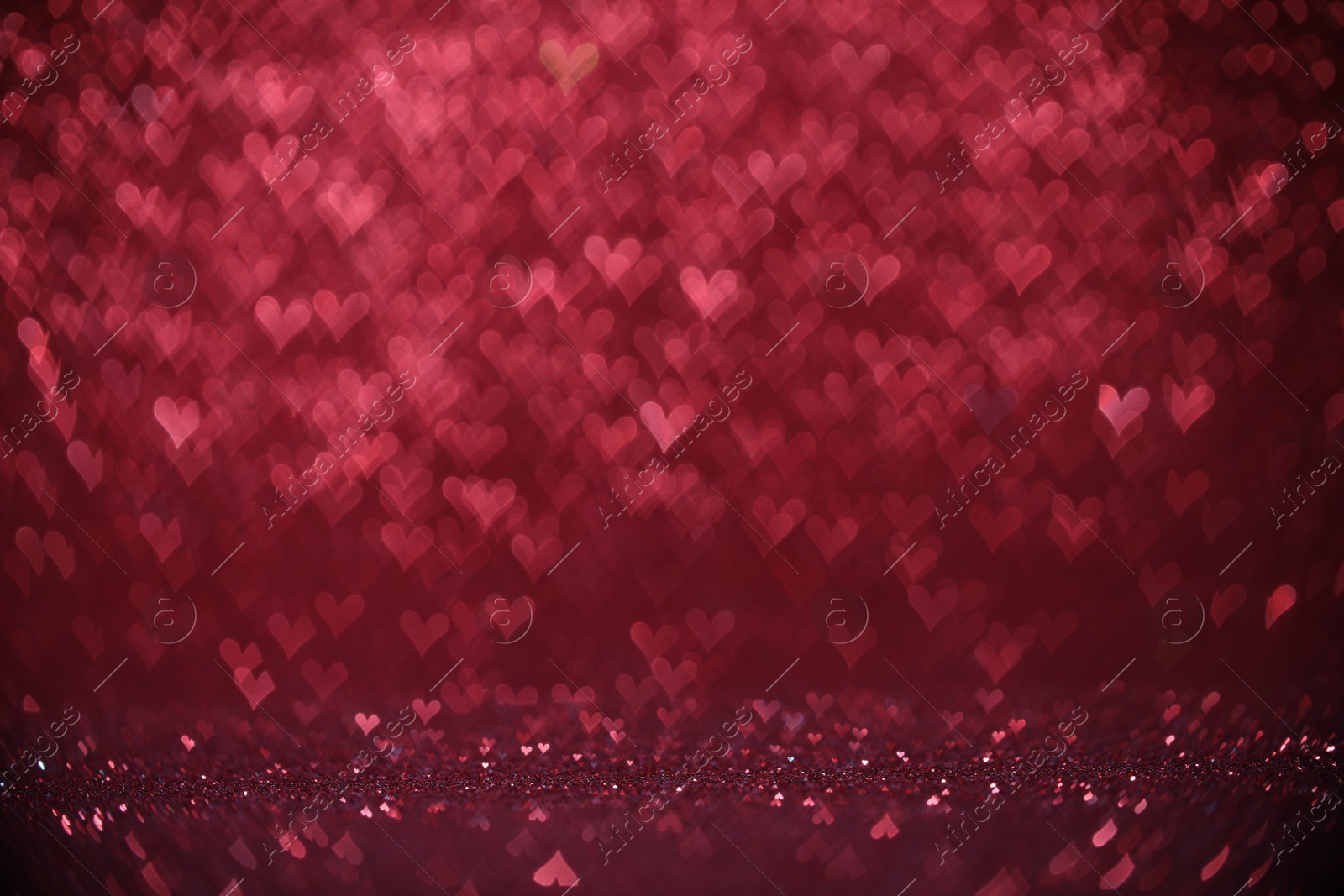 Photo of Shiny pink glitter and blurred heart shaped lights on background, bokeh effect. Romantic decor