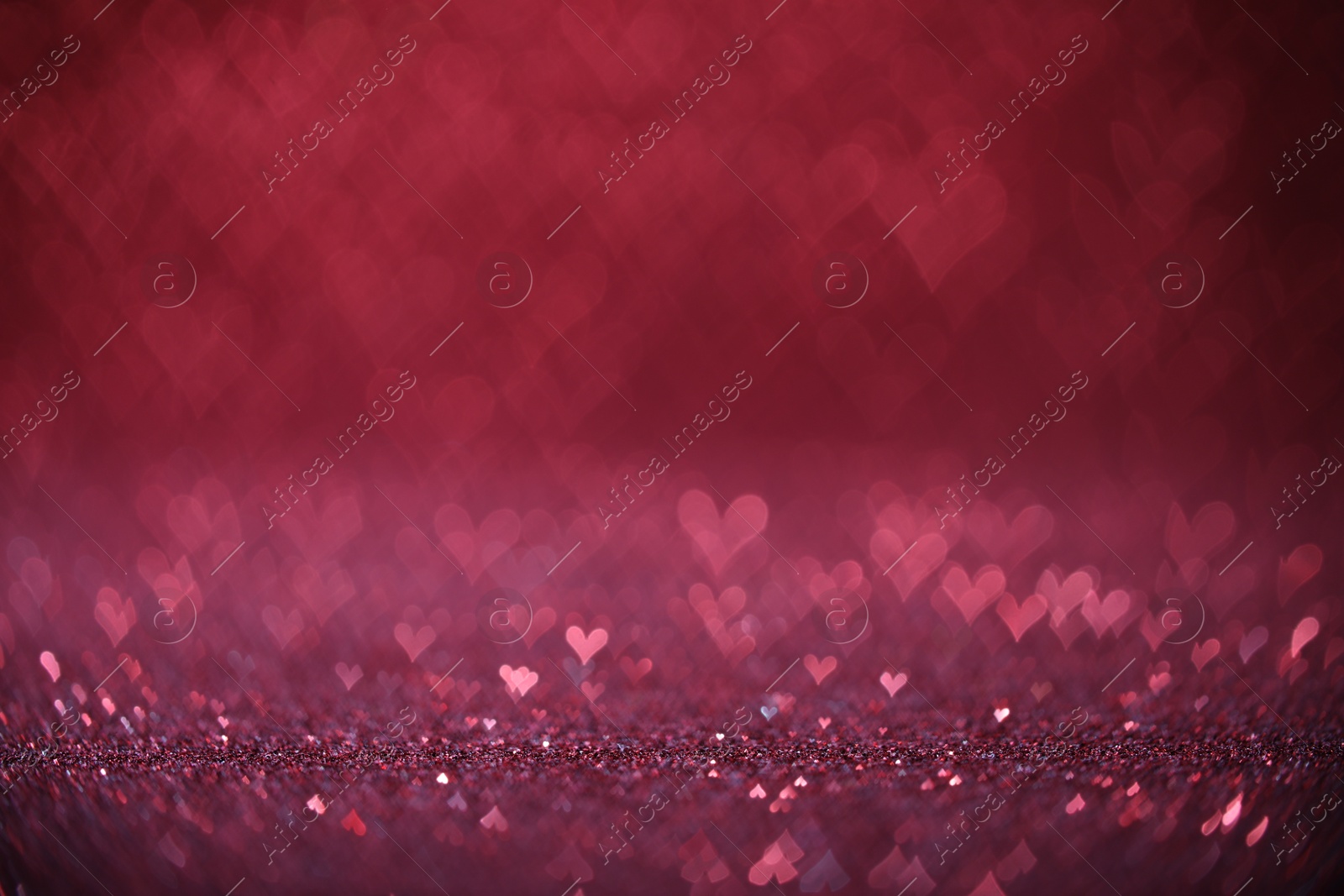 Photo of Shiny pink glitter and blurred heart shaped lights on background, bokeh effect. Romantic decor