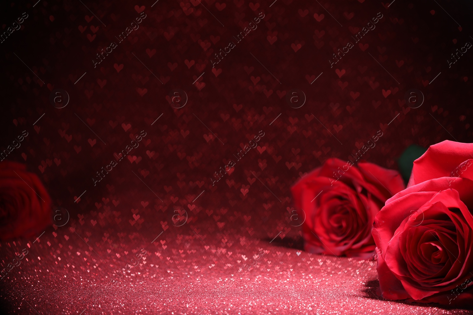 Photo of Romantic decor. Beautiful roses on shiny pink glitter and heart shaped lights, space for text. Bokeh effect