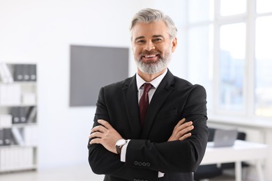 Photo of Portrait of banker with crossed arms in office