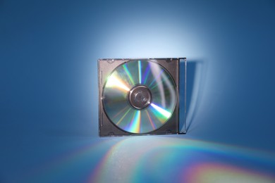 Photo of One compact disc in jewel case on light blue background