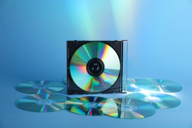 Photo of Many compact discs on light blue background