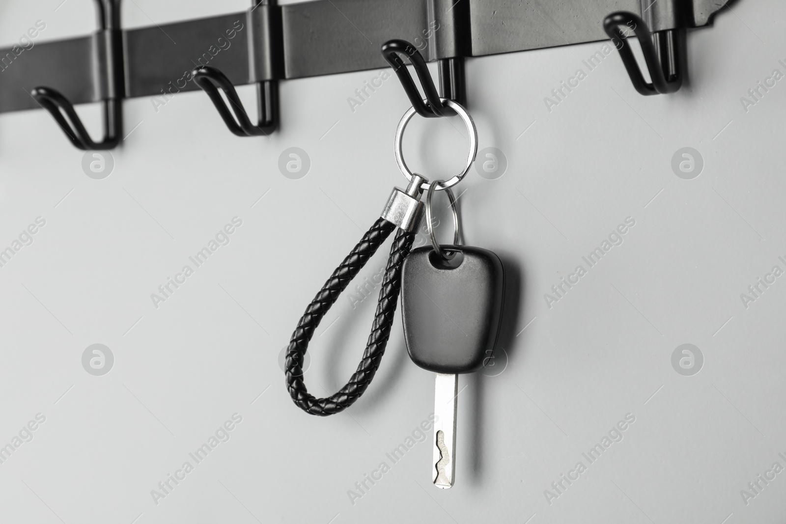 Photo of Car key on hanger against grey wall