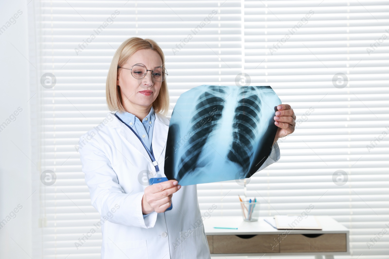 Photo of Doctor examining x-ray image of lungs in clinic