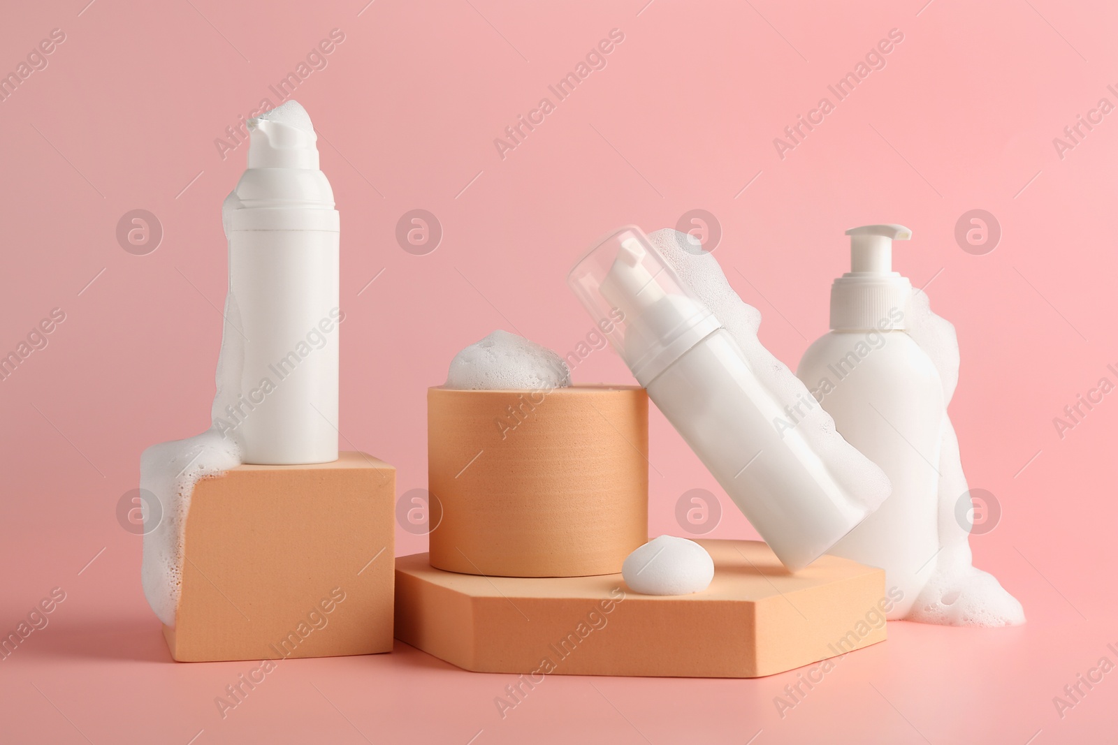 Photo of Presentation of cosmetic products with foam on pink background