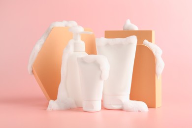 Presentation of cosmetic products with foam on pink background