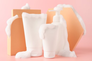 Photo of Presentation of cosmetic products with foam on pink background