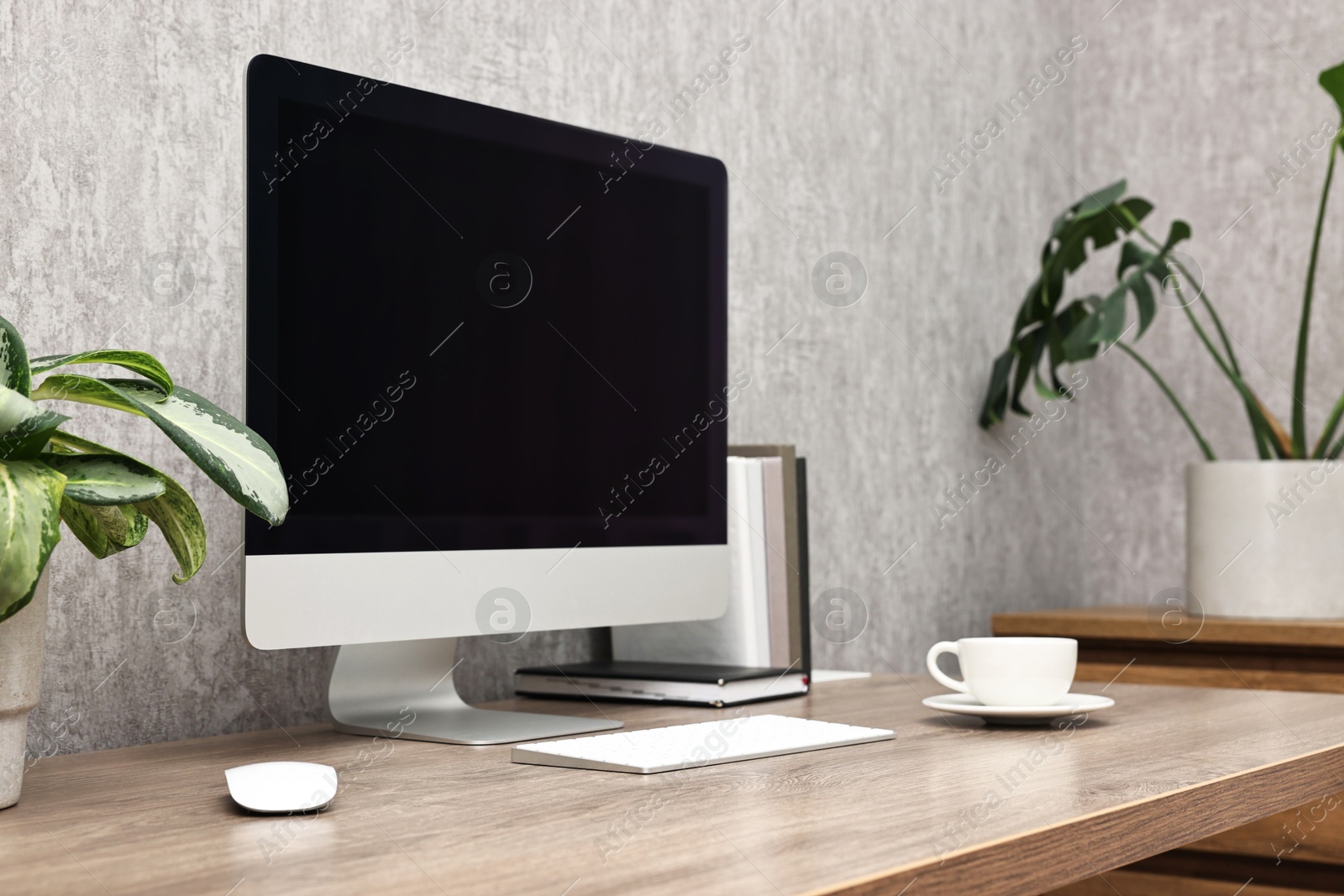 Photo of Comfortable workplace with modern computer on wooden table indoors