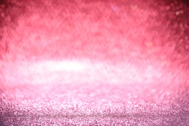 Photo of Shiny pink glitter and blurred heart shaped lights on background, bokeh effect. Romantic decor