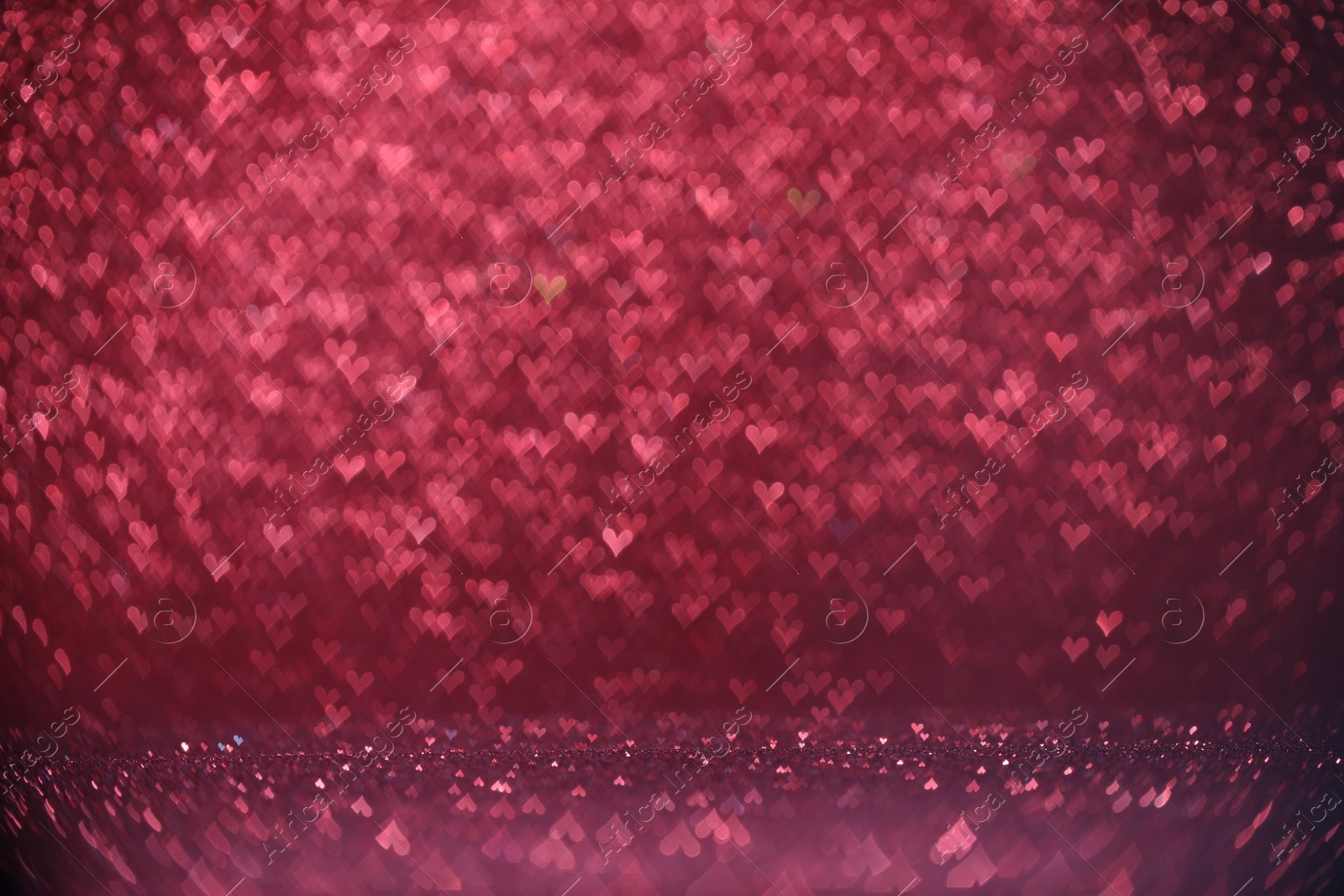 Photo of Shiny pink glitter and blurred heart shaped lights on background, bokeh effect. Romantic decor