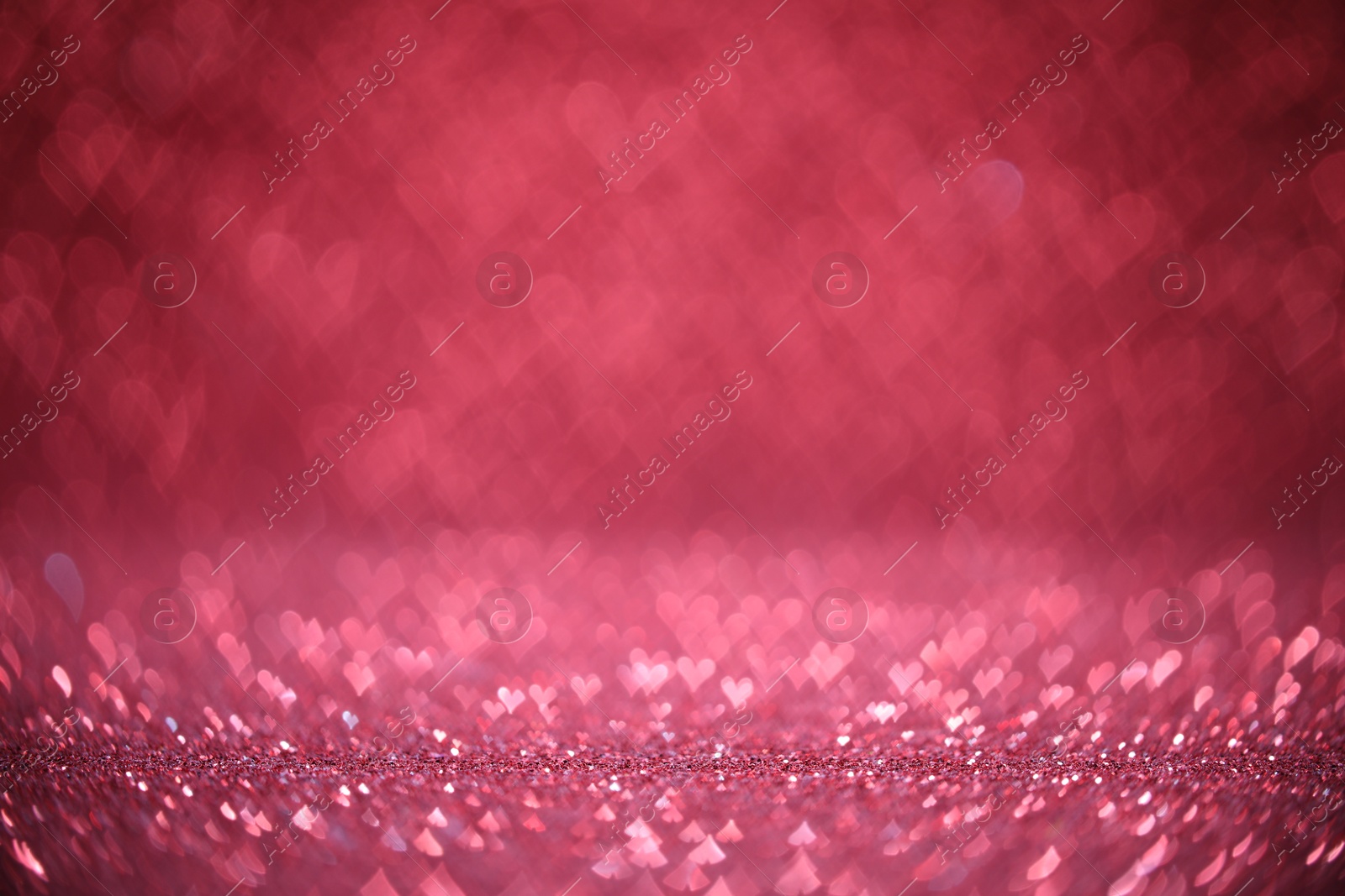 Photo of Shiny pink glitter and blurred heart shaped lights on background, bokeh effect. Romantic decor