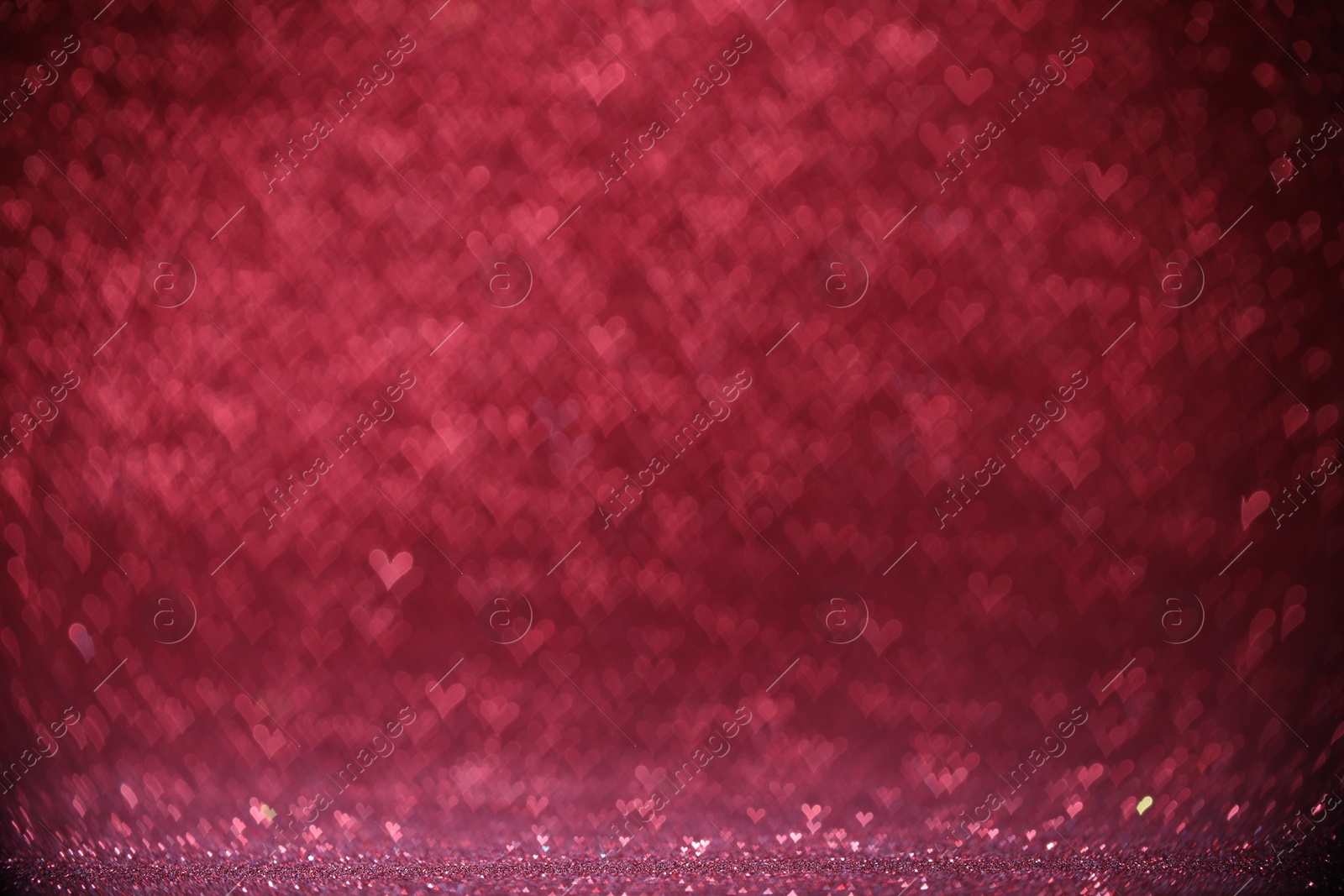 Photo of Shiny pink glitter and blurred heart shaped lights on background, bokeh effect. Romantic decor