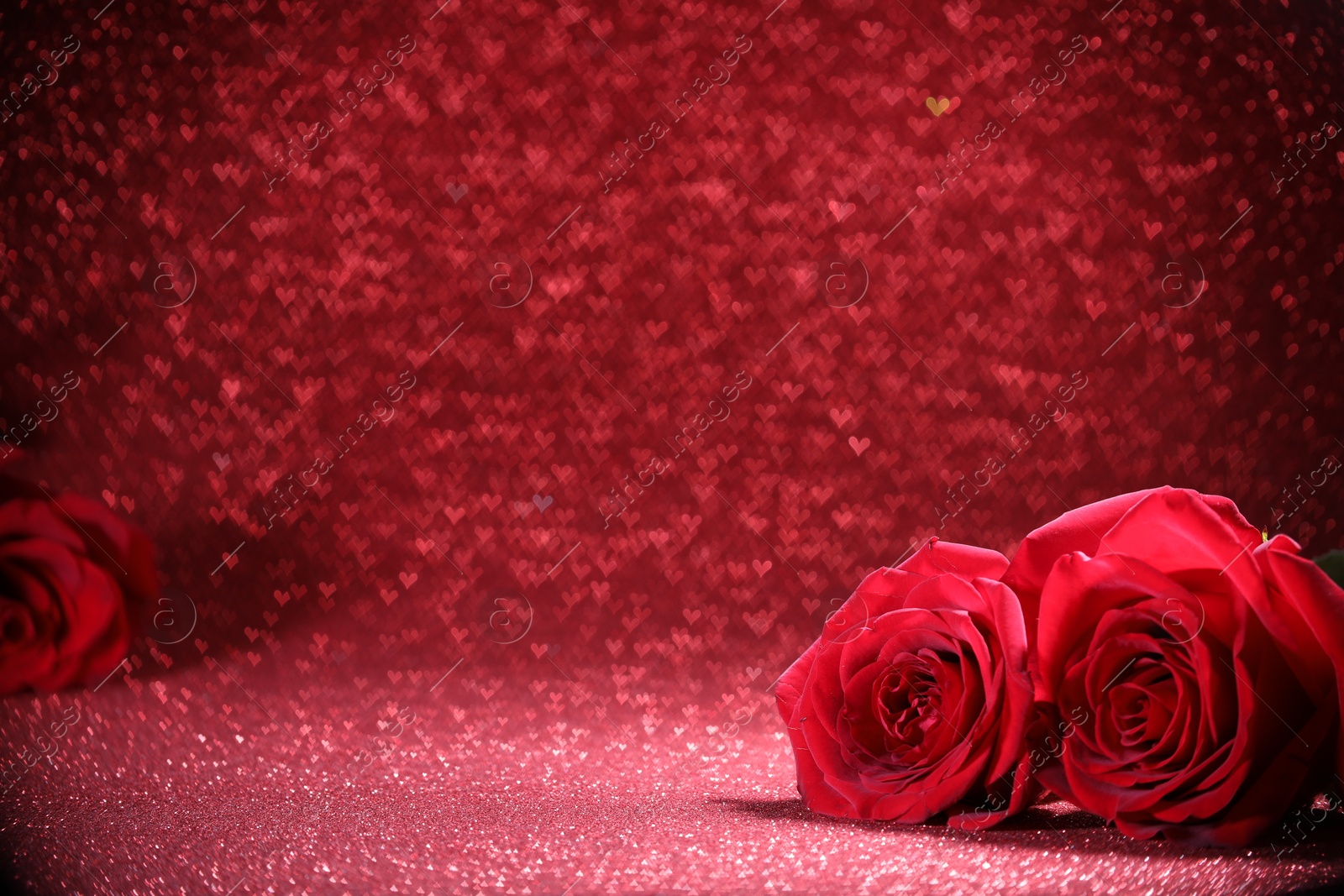 Photo of Romantic decor. Beautiful roses on shiny pink glitter and heart shaped lights, space for text. Bokeh effect