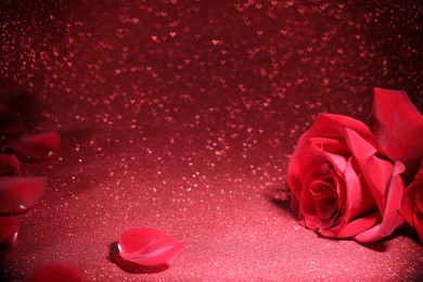 Photo of Romantic decor. Beautiful roses on shiny pink glitter and heart shaped lights, space for text. Bokeh effect