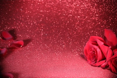 Photo of Romantic decor. Beautiful roses on shiny pink glitter and heart shaped lights, space for text. Bokeh effect