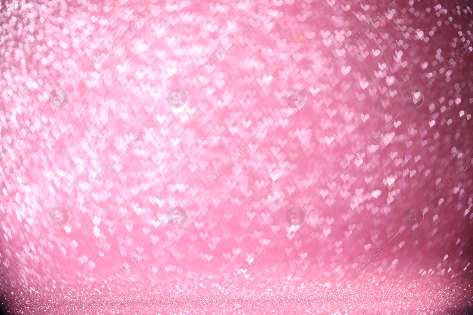 Photo of Shiny pink glitter and blurred heart shaped lights on background, bokeh effect. Romantic decor