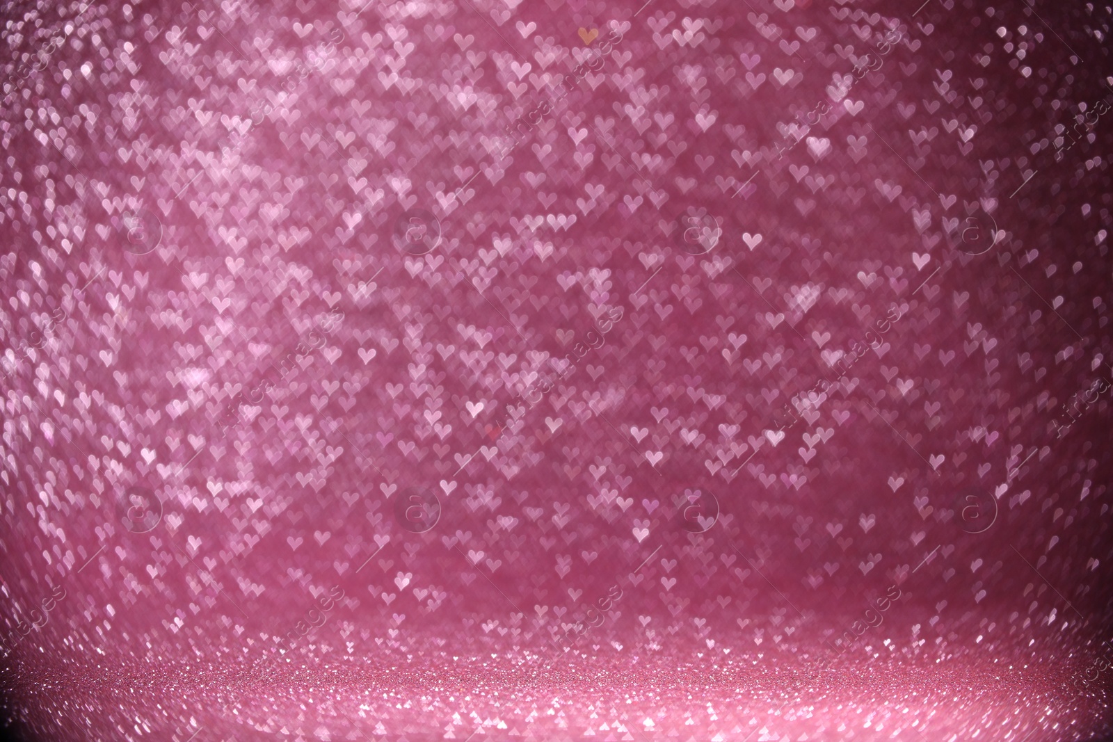 Photo of Shiny pink glitter and blurred heart shaped lights on background, bokeh effect. Romantic decor