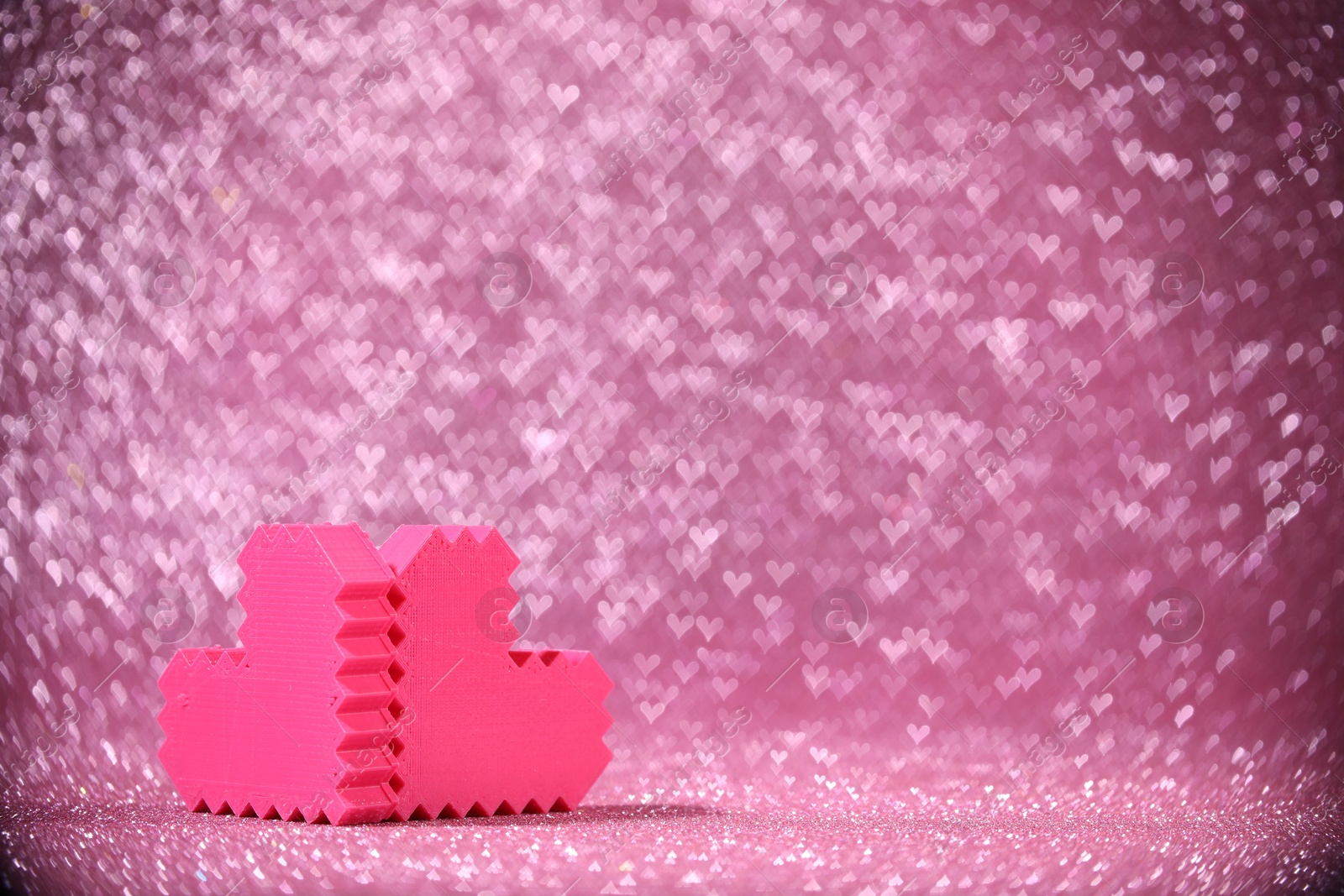 Photo of Romantic decor. Small hearts on shiny pink glitter and heart shaped lights, space for text. Bokeh effect