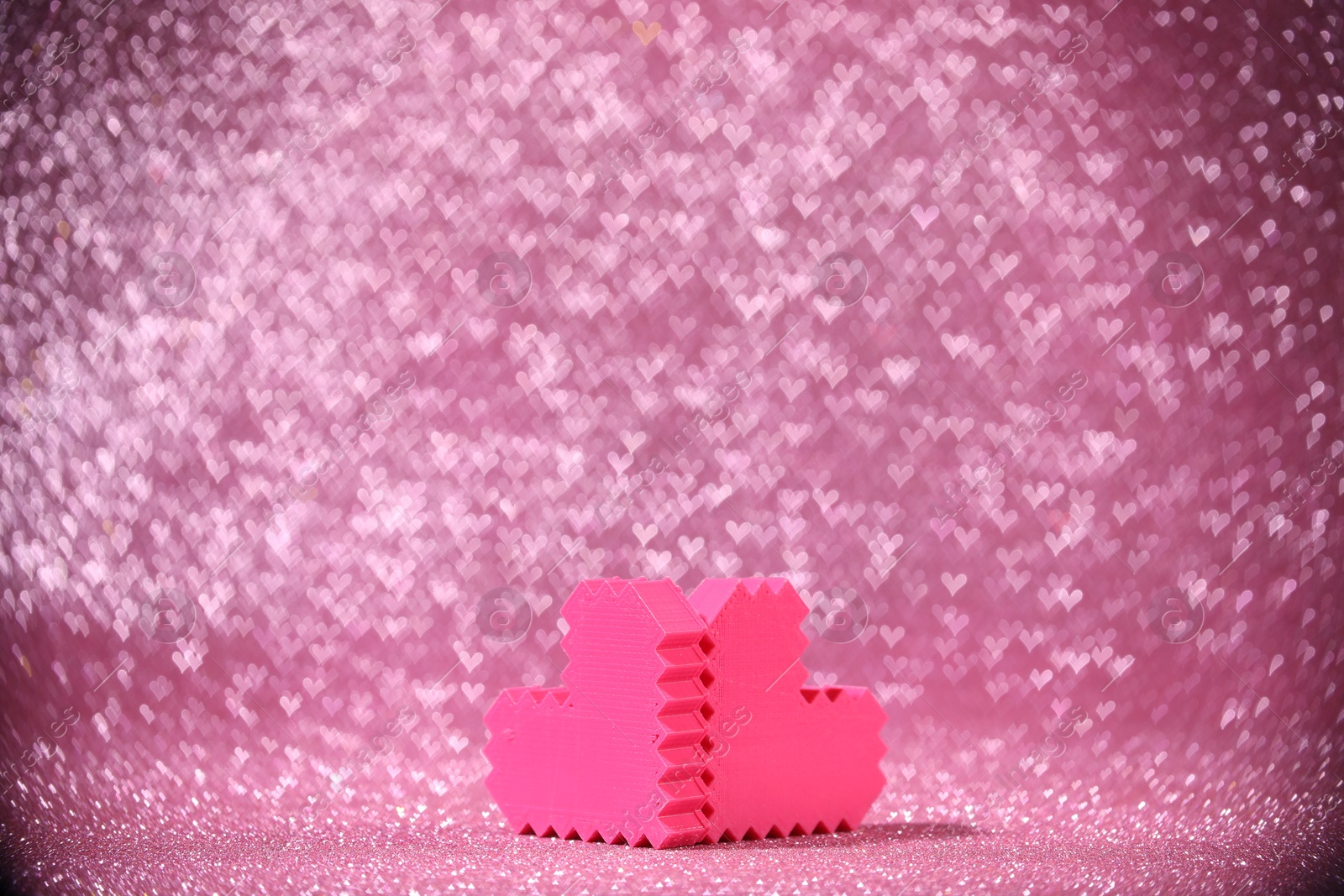 Photo of Romantic decor. Small hearts on shiny pink glitter and heart shaped lights, space for text. Bokeh effect