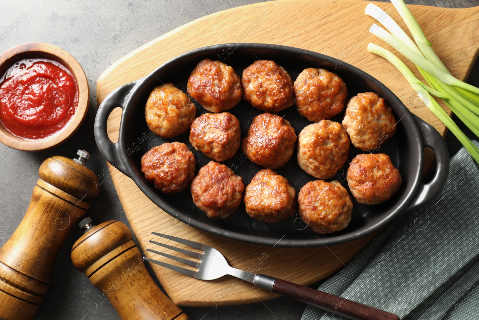 Photo of Tasty meatballs served on grey table, flat lay