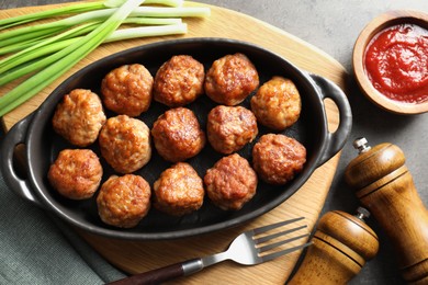 Photo of Tasty meatballs served on grey table, flat lay