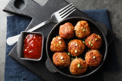 Photo of Tasty meatballs served on grey table, flat lay