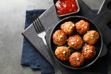 Photo of Tasty meatballs served on grey table, flat lay