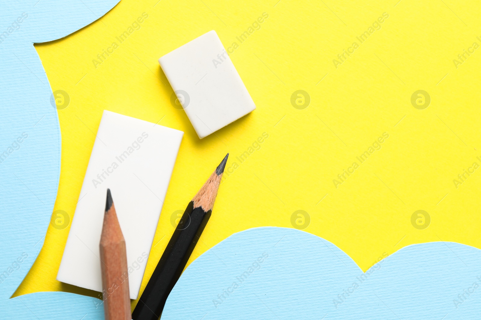 Photo of Erasers and pencils on color background, flat lay. Space for text