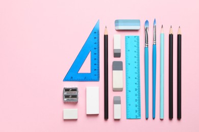 Photo of Erasers and other different stationery on pink background, flat lay. Space for text