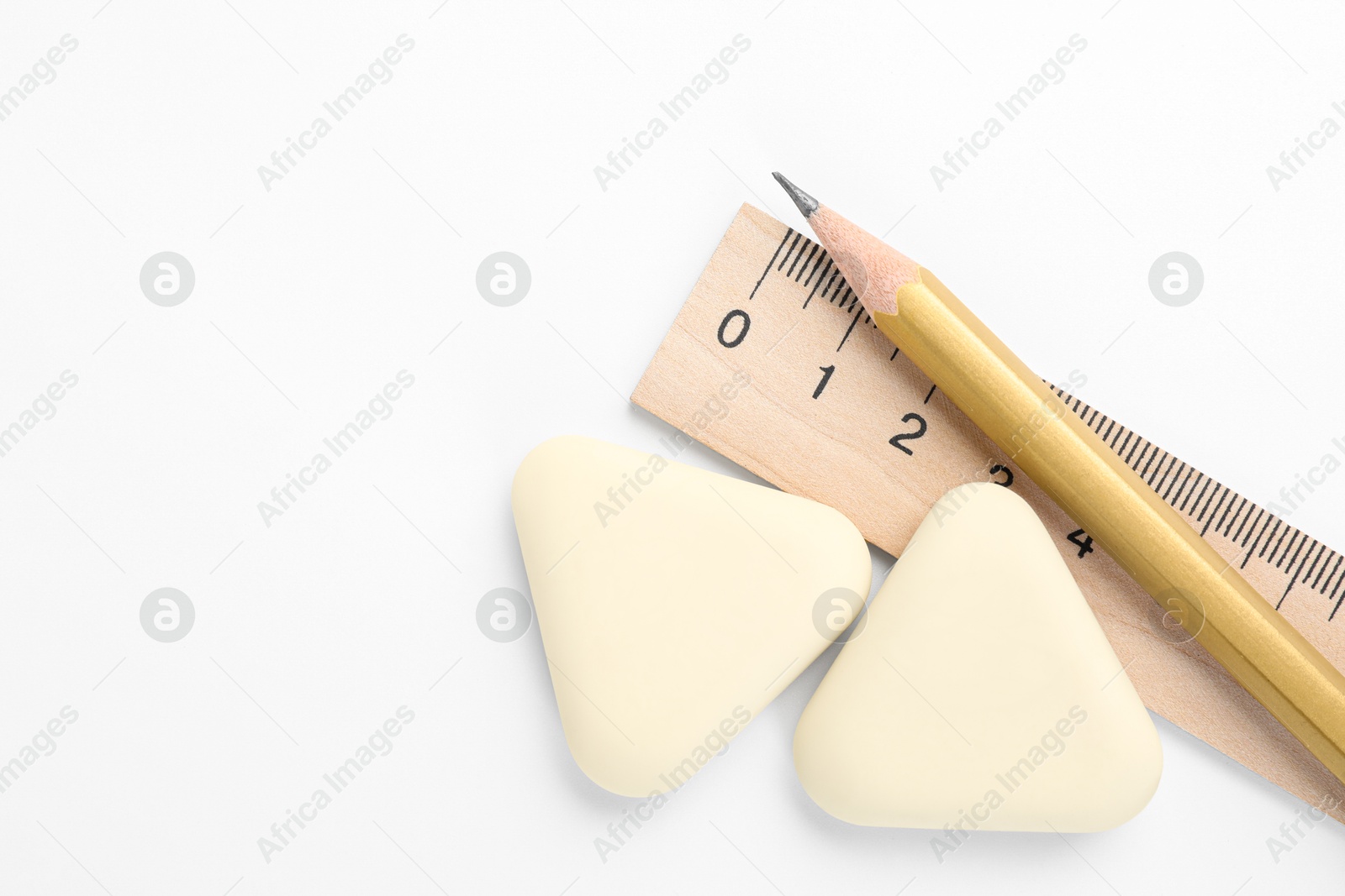 Photo of Erasers, ruler and pencil on white background, flat lay. Space for text