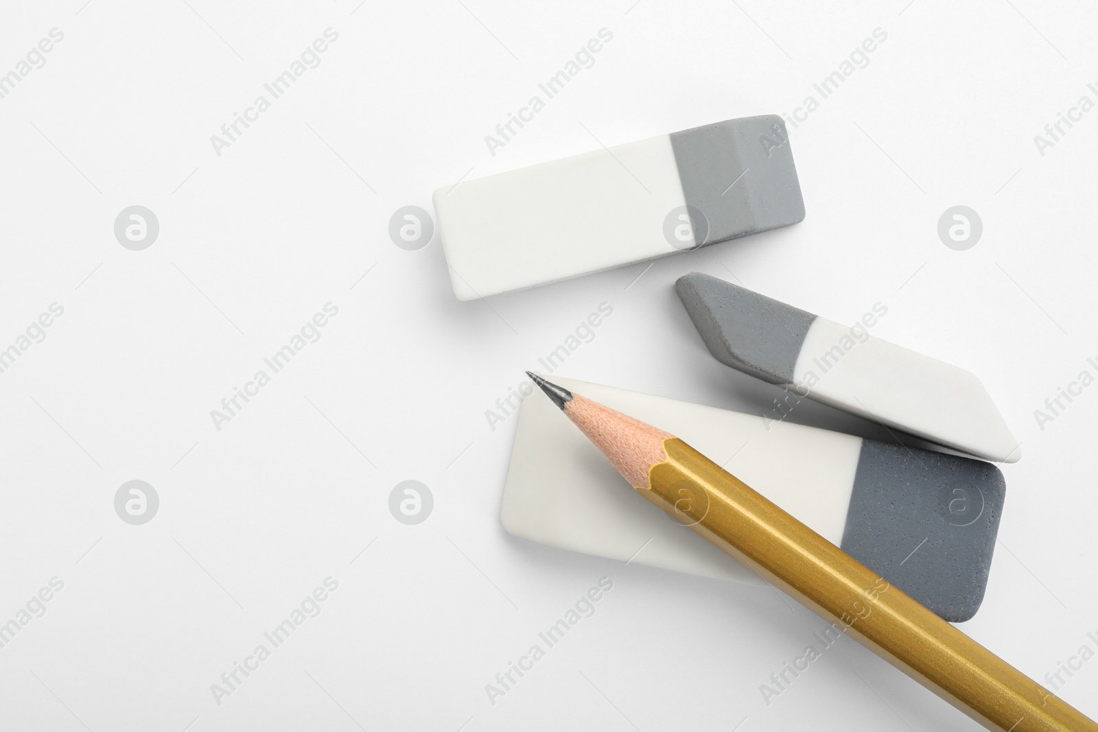 Photo of Erasers and pencil on white background, flat lay. Space for text