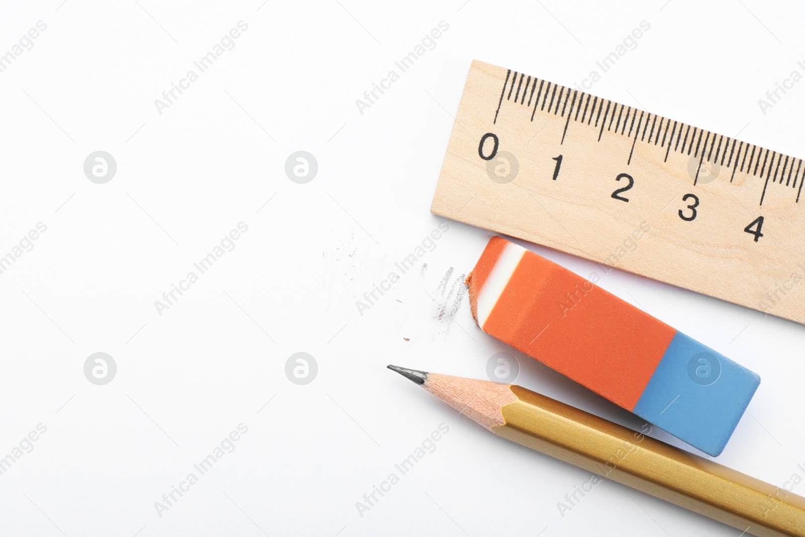 Photo of Eraser, ruler and pencil on white background, flat lay. Space for text