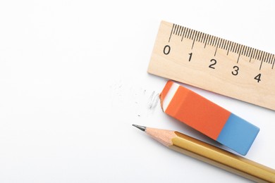 Photo of Eraser, ruler and pencil on white background, flat lay. Space for text