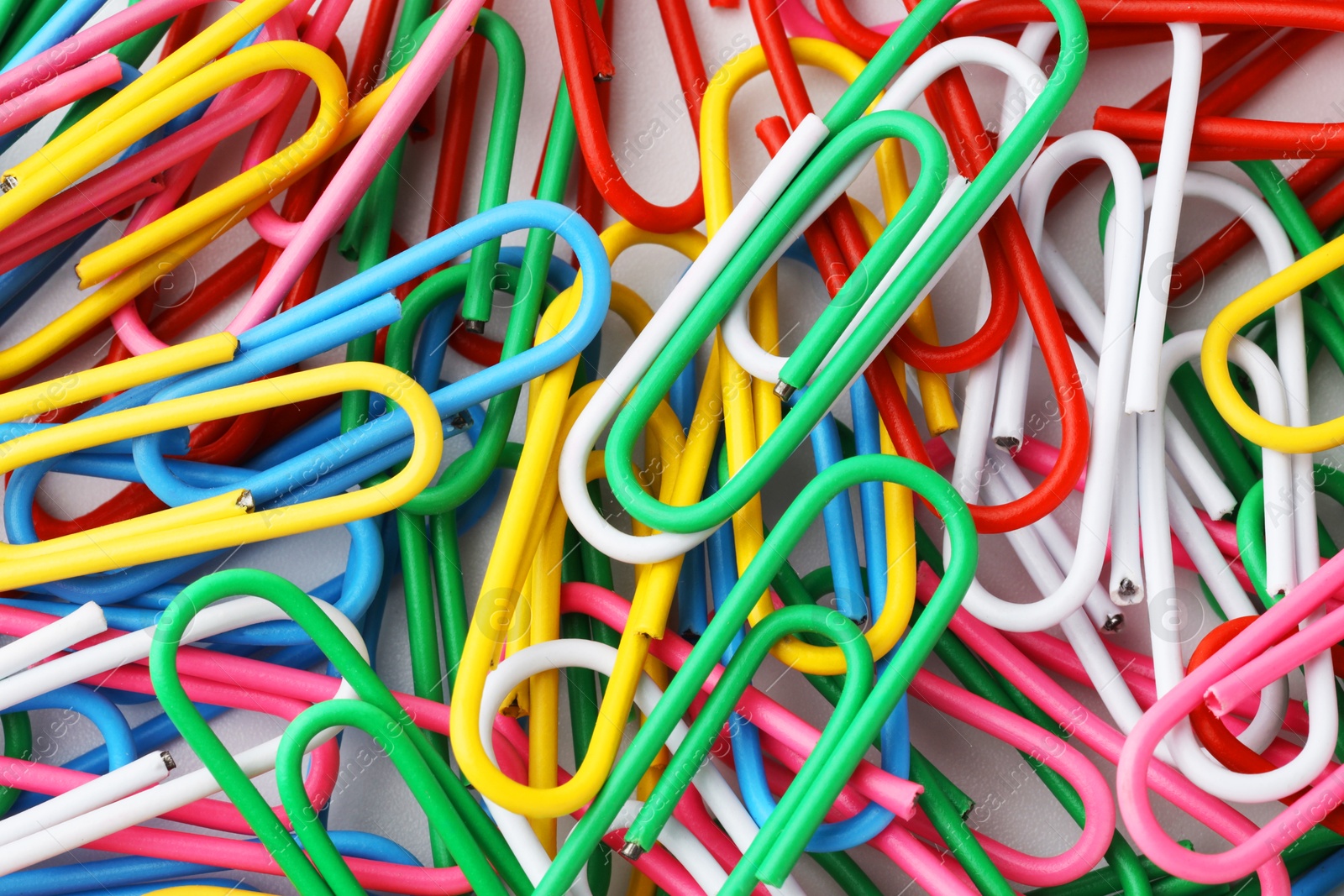 Photo of Many colorful paper clips on white background, top view