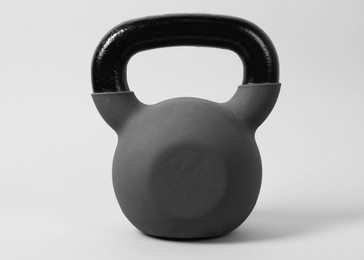 Photo of One metal kettlebell on grey background. Sports equipment