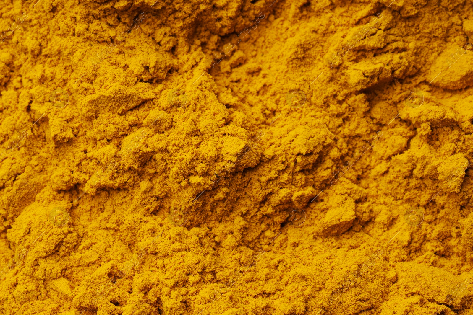 Photo of Aromatic turmeric powder as background, top view