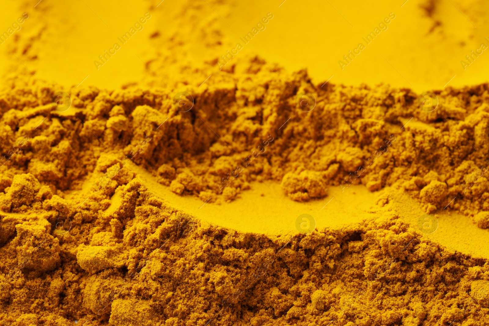 Photo of Aromatic turmeric powder as background, closeup view