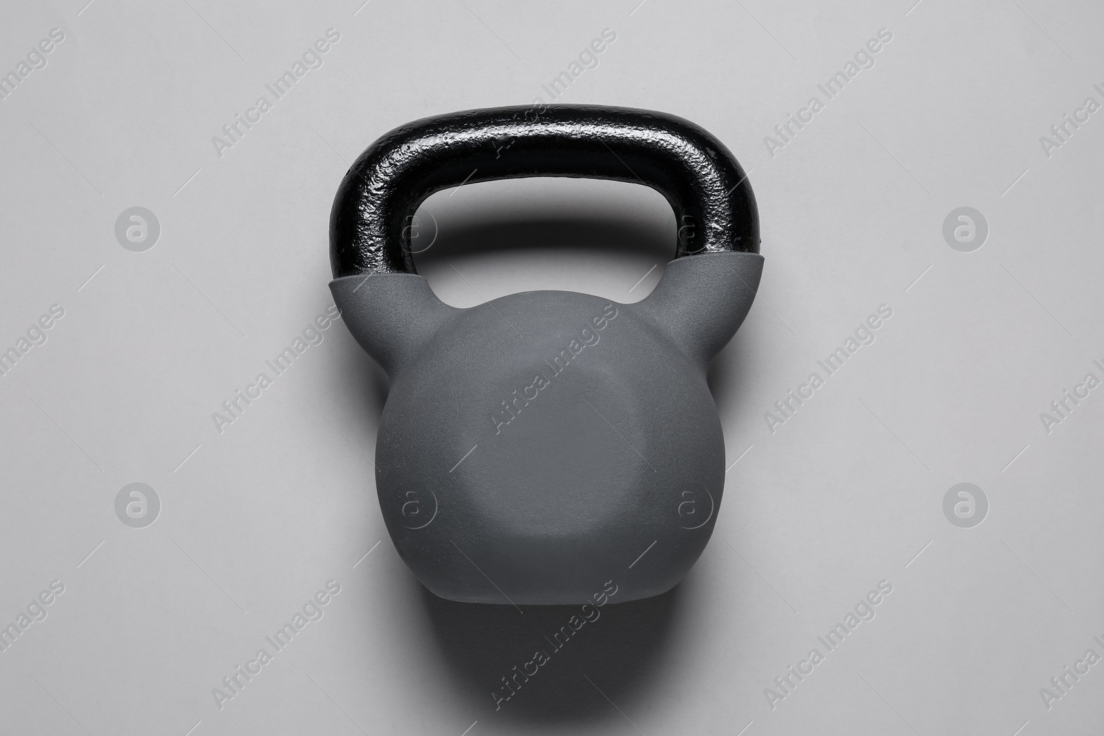 Photo of One kettlebell on light grey background, top view