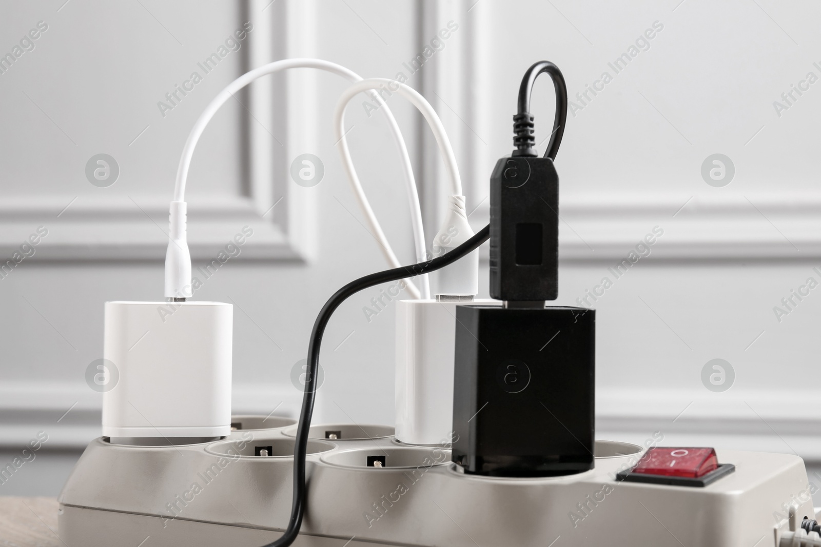 Photo of USB adapters with charge cables in power strip, closeup